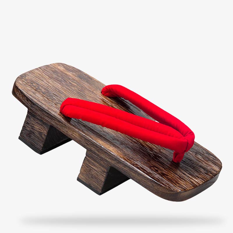 Von einem Kunsthandwerker gefertigte Geta Sandalen aus Holz mit rotem Hanao Riemen
